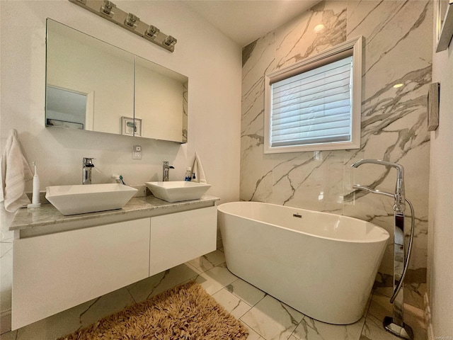 bathroom with a washtub and vanity