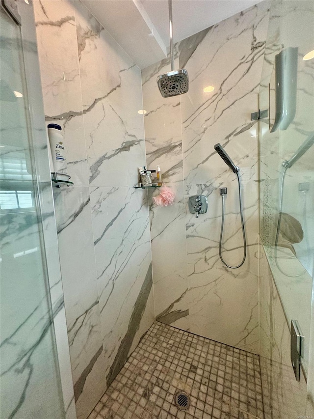 bathroom with a tile shower