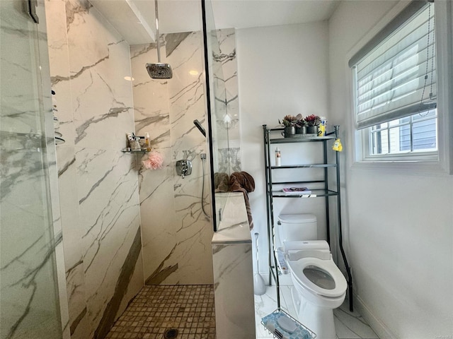 bathroom featuring toilet and a tile shower