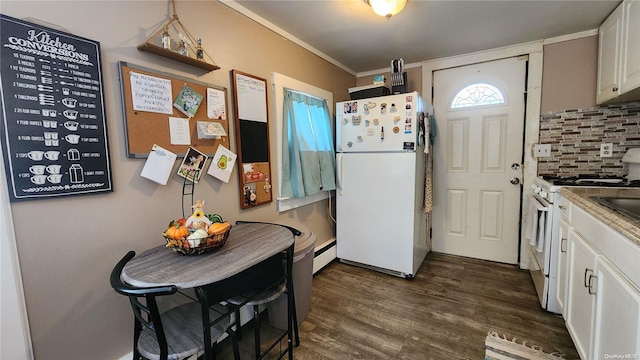 kitchen with dark wood-type flooring, tasteful backsplash, crown molding, white appliances, and white cabinets