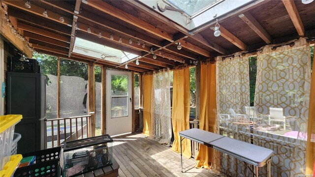 misc room with a skylight and hardwood / wood-style floors