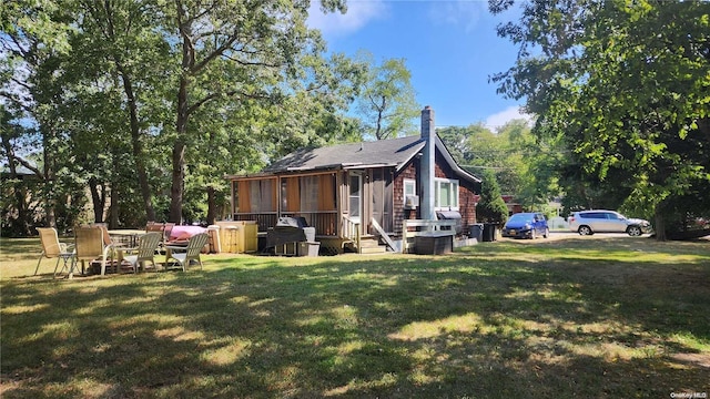 view of property exterior featuring a lawn and a sunroom