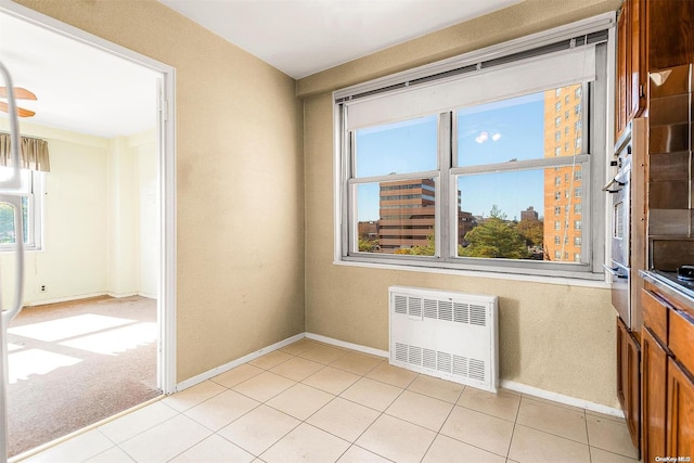 tiled empty room featuring radiator