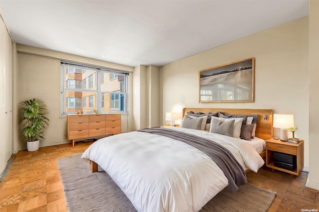 bedroom featuring parquet flooring