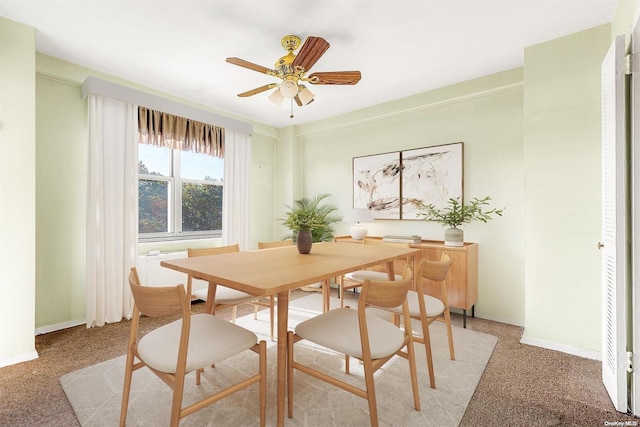 dining room featuring light carpet and ceiling fan