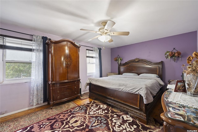 bedroom with ceiling fan and hardwood / wood-style floors