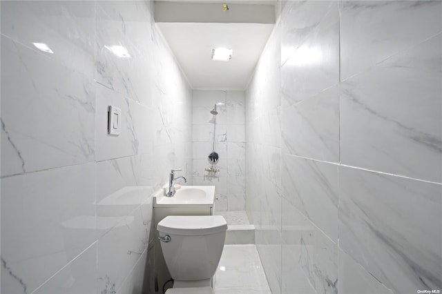 bathroom with a shower, tile walls, and toilet