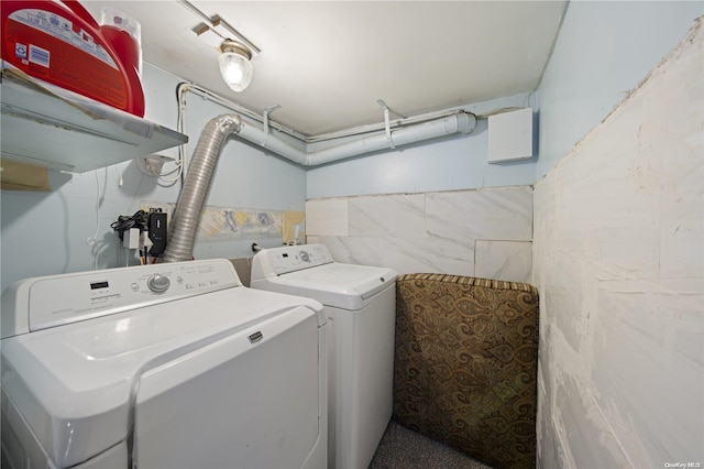 clothes washing area featuring washing machine and clothes dryer