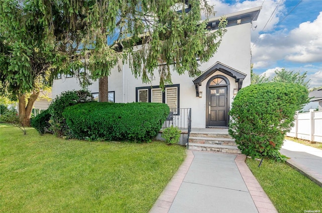 entrance to property with a lawn