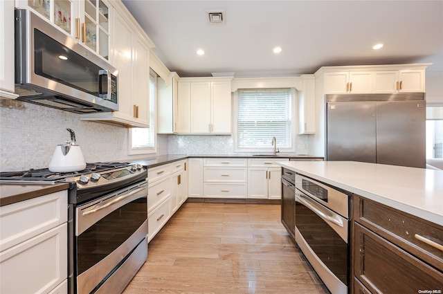 kitchen featuring tasteful backsplash, plenty of natural light, and stainless steel appliances