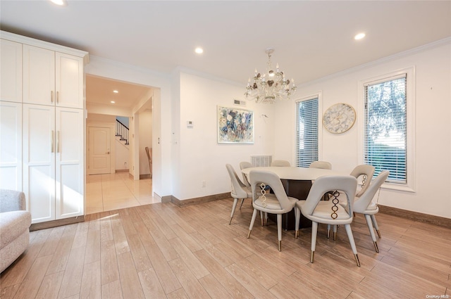 dining room featuring a chandelier, light hardwood / wood-style floors, and ornamental molding