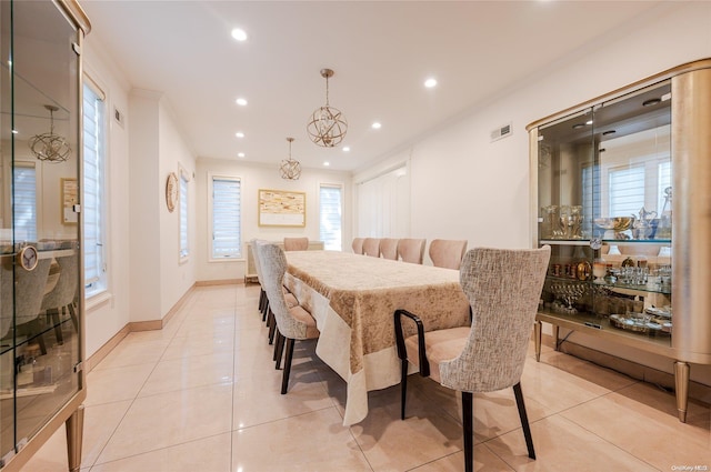 dining area with light tile patterned floors and a chandelier