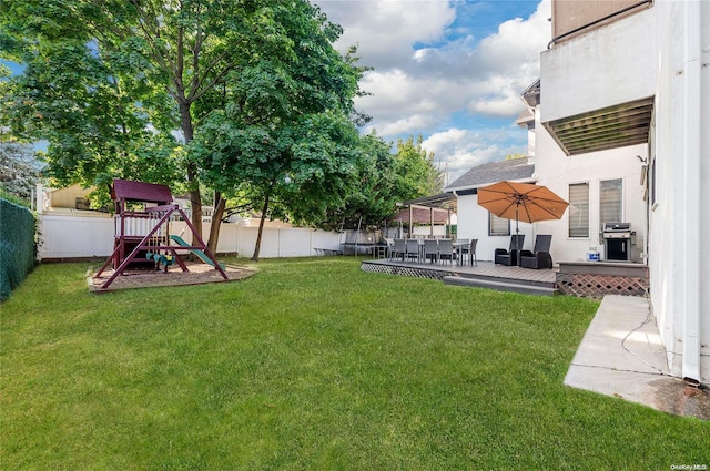 view of yard with a playground and a wooden deck