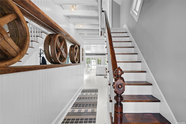 stairs featuring french doors and beamed ceiling