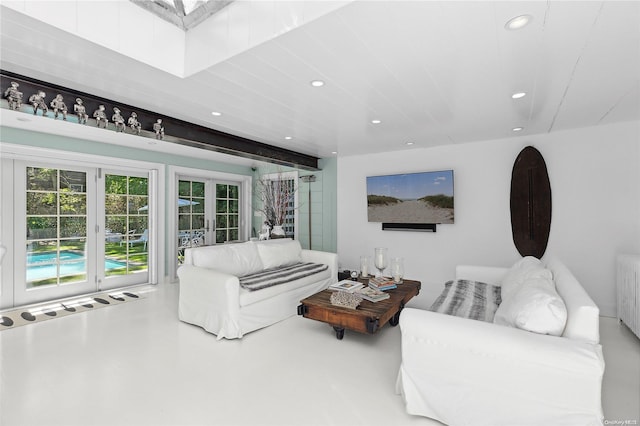 living room featuring concrete floors, radiator, and french doors