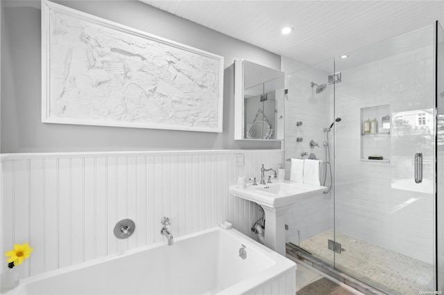 bathroom featuring separate shower and tub