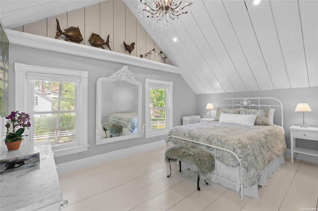 bedroom with lofted ceiling, radiator, and a chandelier