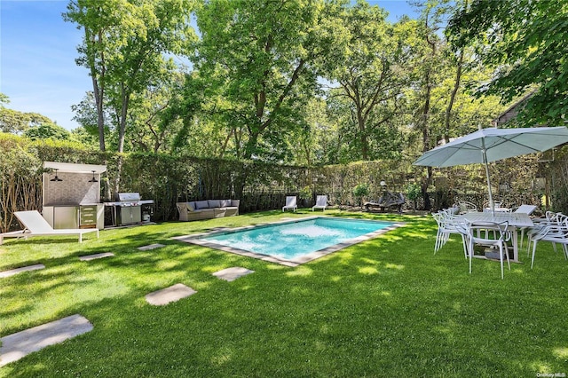 view of swimming pool with a lawn, an outdoor living space, a shed, and grilling area