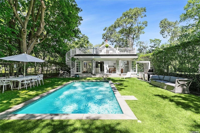 rear view of property with a patio area, an outdoor hangout area, and a yard