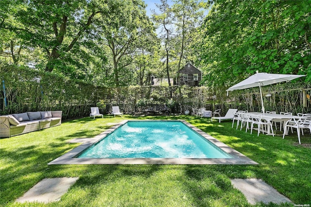 view of pool with a yard