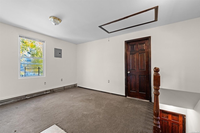 carpeted spare room featuring electric panel and a baseboard heating unit