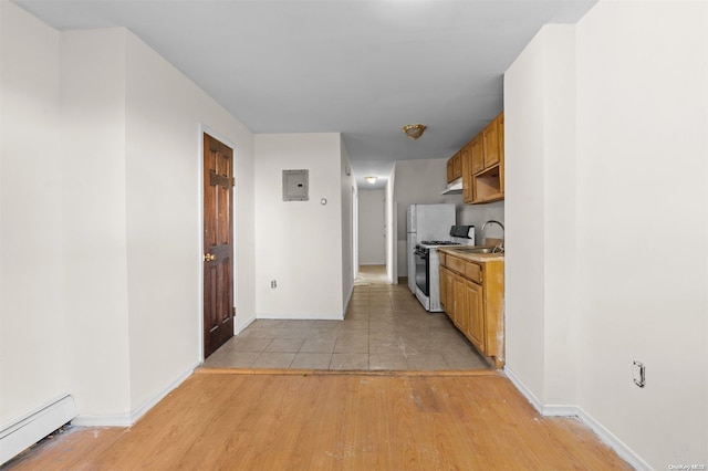 kitchen featuring electric panel, a baseboard heating unit, sink, light hardwood / wood-style flooring, and white range with gas cooktop