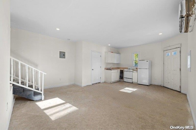 unfurnished living room with light carpet