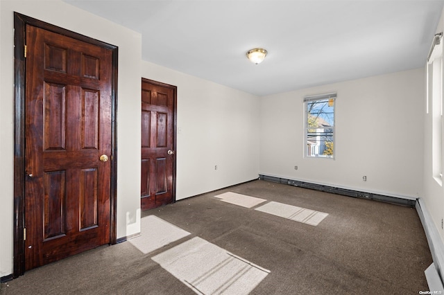 unfurnished room featuring carpet and a baseboard heating unit