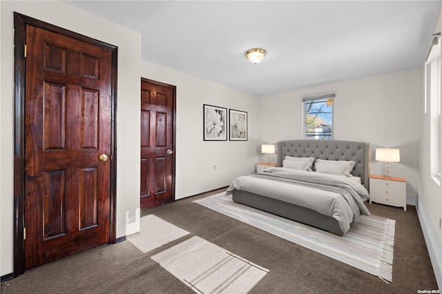 bedroom featuring dark colored carpet