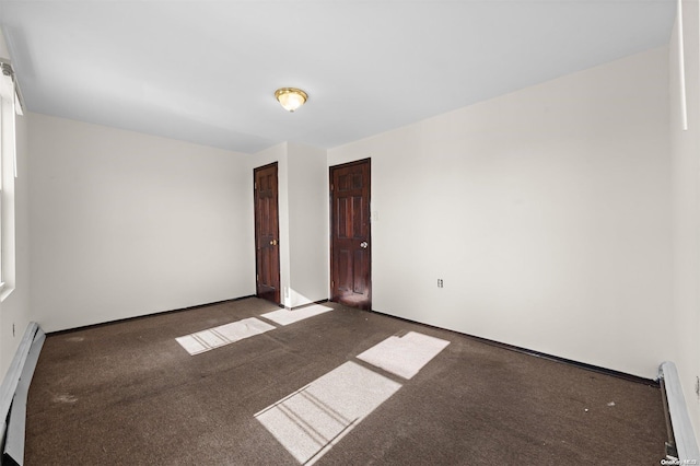 carpeted spare room with baseboard heating