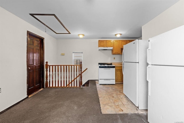 kitchen featuring white appliances and light brown cabinetry