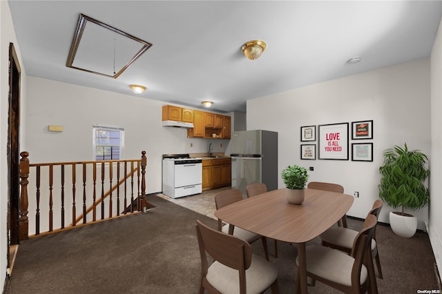 dining room featuring light colored carpet and sink