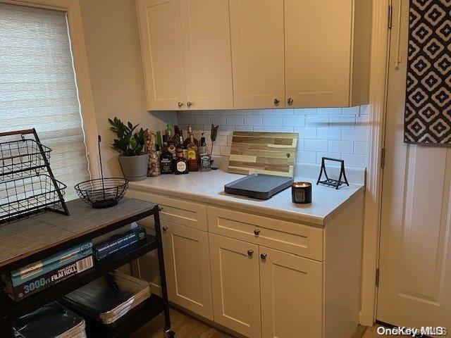 kitchen featuring decorative backsplash and white cabinetry