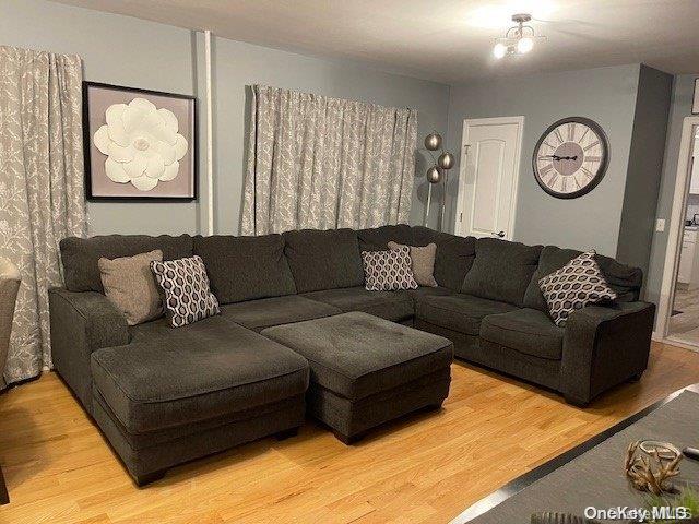 living room featuring hardwood / wood-style flooring and a chandelier