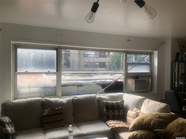 living room featuring ceiling fan and cooling unit