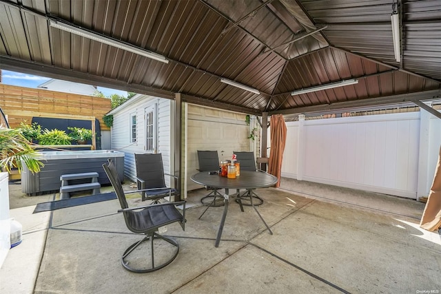 view of patio / terrace featuring a gazebo and a hot tub