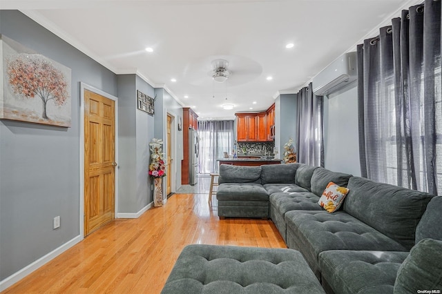 living room with a wall unit AC, crown molding, ceiling fan, and light hardwood / wood-style floors