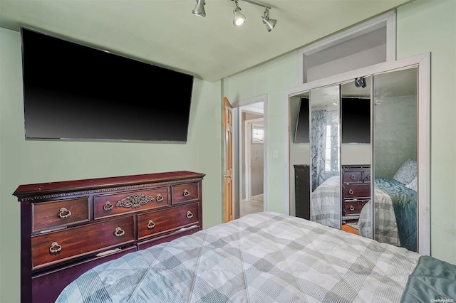 bedroom with a closet and rail lighting