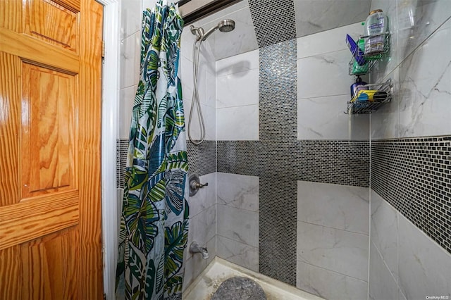 bathroom with shower / bath combo and tile walls