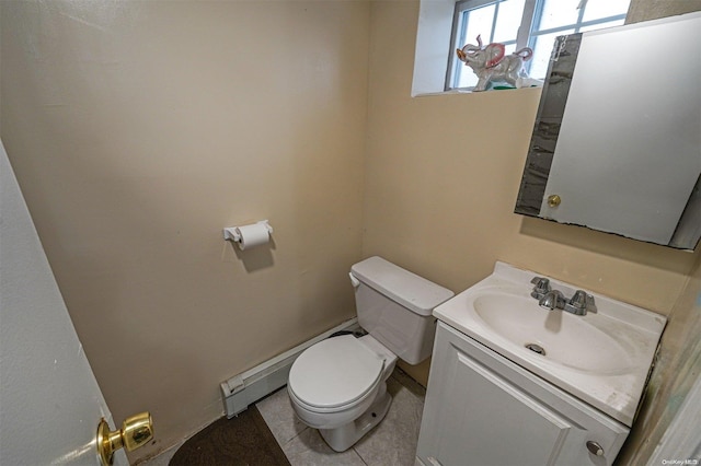 bathroom with tile patterned flooring, vanity, toilet, and a baseboard heating unit