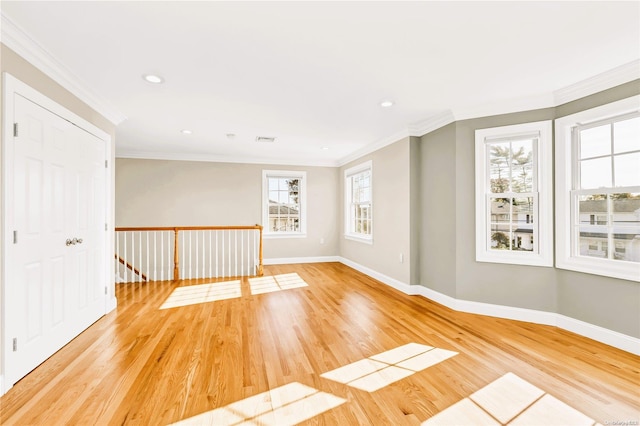 empty room featuring light hardwood / wood-style floors and ornamental molding