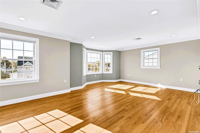 unfurnished room with light hardwood / wood-style floors and crown molding