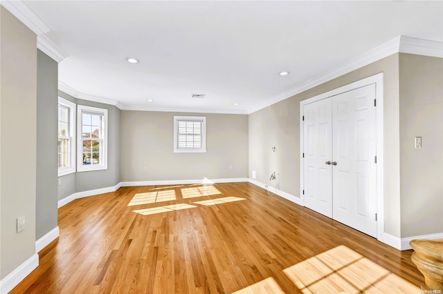 empty room with light wood-type flooring and ornamental molding