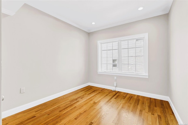 unfurnished room featuring hardwood / wood-style flooring and ornamental molding