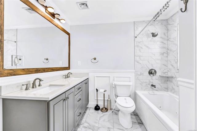 full bathroom featuring vanity, toilet, tiled shower / bath, and ornamental molding