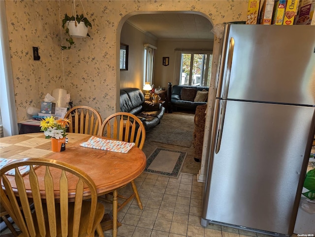 tiled dining room with ornamental molding