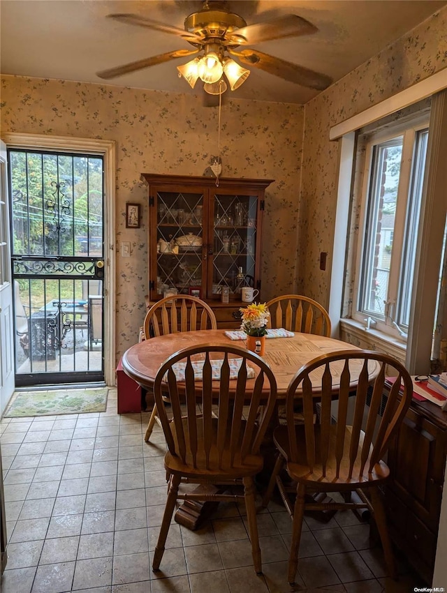 tiled dining space with a wealth of natural light and ceiling fan