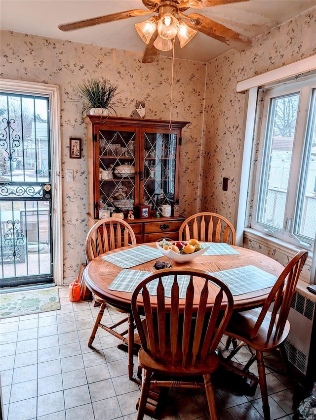 tiled dining space featuring ceiling fan