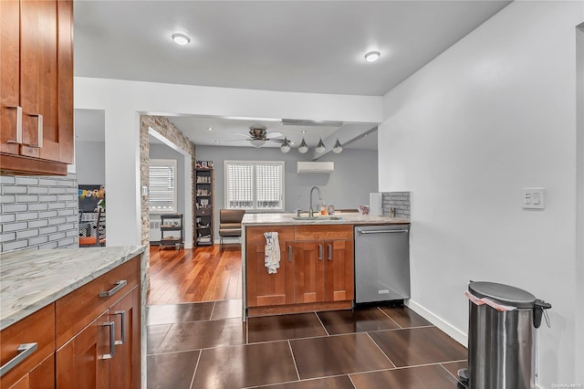 kitchen featuring stainless steel dishwasher, ceiling fan, dark wood-type flooring, sink, and an AC wall unit