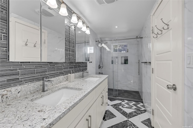 bathroom with vanity, tasteful backsplash, walk in shower, and tile walls